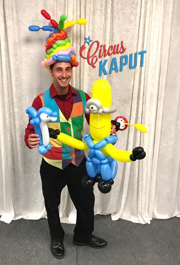 Colorful balloon twister holds up deluxe balloon creations