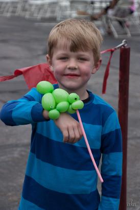 Littl boy shows off wearable balloon turtle in Florissant Missouri at festival