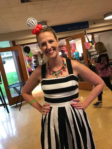Adult wears a fun balloon hat in University City Missouri at evening gala